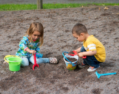 kids playing outdoors with shovels and other outdoor toys