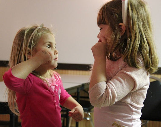 children teaching each other sign language